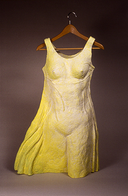 A ceramic sculpture of a female body appearing through a yellow-green dress.